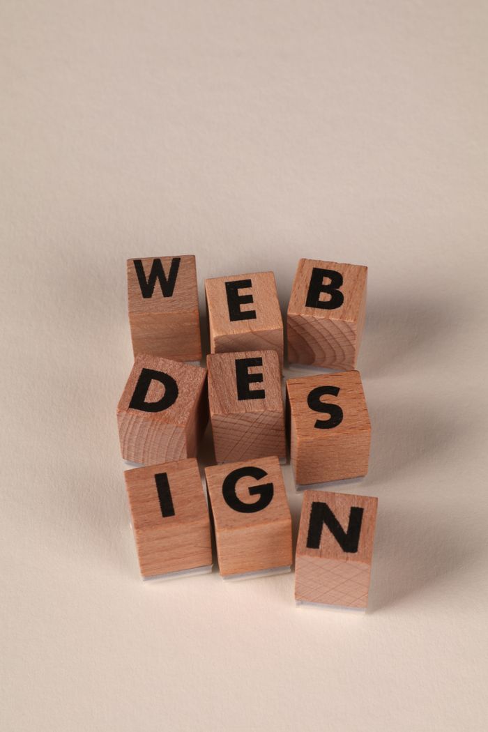 Wooden blocks laid out to form Web Design. Ideal for creative, digital content themes.