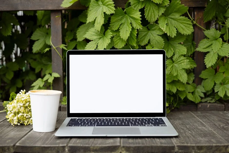 Close-up of hands interacting with a shopping website on a laptop screen indoors.